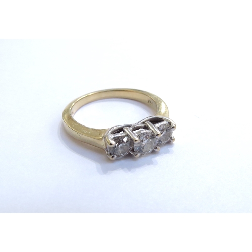 6322 - A three stone diamond ring in stepped mount 0.65ct total approx, stamped 14k. Size O, 4.4g