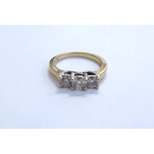 6322 - A three stone diamond ring in stepped mount 0.65ct total approx, stamped 14k. Size O, 4.4g