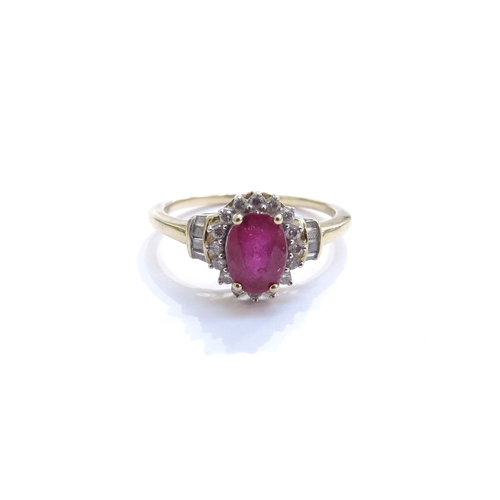 6050 - A ruby and diamond cluster ring, the central oval ruby framed by diamonds with diamond set shoulders... 