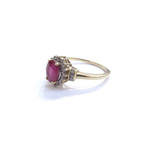 6050 - A ruby and diamond cluster ring, the central oval ruby framed by diamonds with diamond set shoulders... 