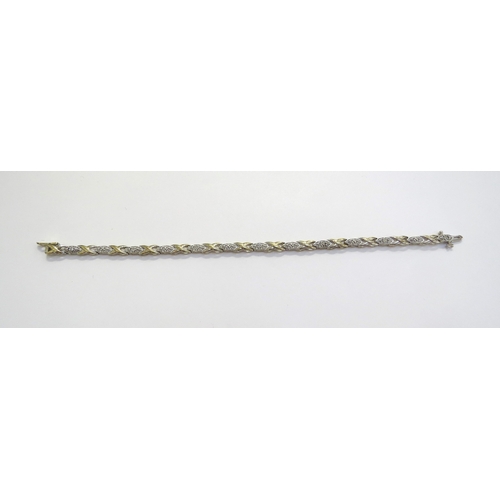 6394 - A gold bracelet stamped 10k with diamond set links, 17.5cm long, 7.5g