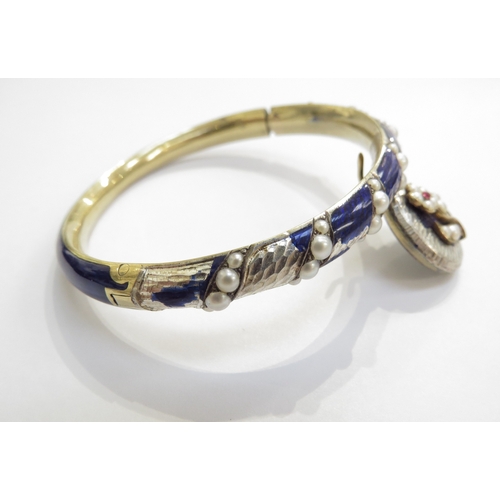 6239 - A 19th Century enamel bangle with pearl inset, hung with a hair panel pendant, enamel damaged/losses... 