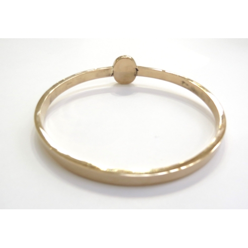 6143 - A 15ct gold bangle Chester 1902 with later oval panel set with a single diamond 0.20ct approx, 15.2g