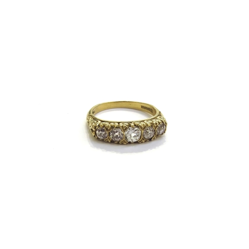 6265 - An 18ct gold five stone graduated diamond ring, scroll mount. Size O, 5.4g