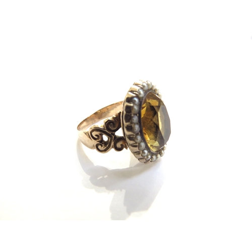 6014 - A Victorian citrine and seed pearl ring with open heart scroll shoulders, unmarked. Size N/O, 7g