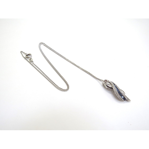 6391 - A 9ct white gold diamond and sapphire pendant hung on a 9ct white gold chain, 44cm long, 3.9g