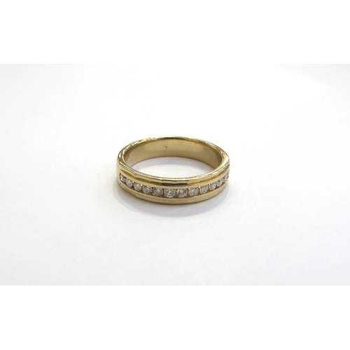 6067 - A ring with a row of channel set diamonds in 9ct gold shank 0.25ct total. Size L/M, 4.3g