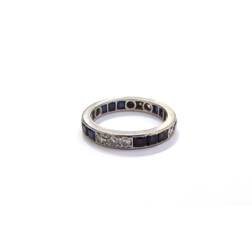 6057 - A sapphire and diamond eternity ring in unmarked white metal. Size M, 4.1g