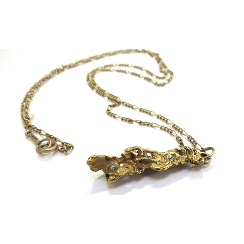 6119 - An unmarked gold nugget pendant set with three old cut diamonds, hung on gold chain, 56cm long, 9.4g