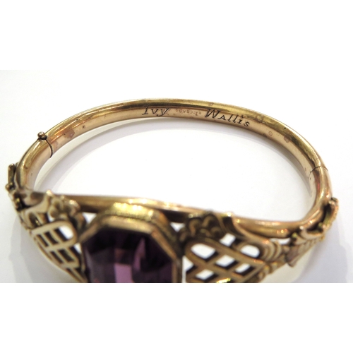 6310 - A Victorian gold filled Bates and Bacon bangle set centrally with an amethyst coloured stone with or... 