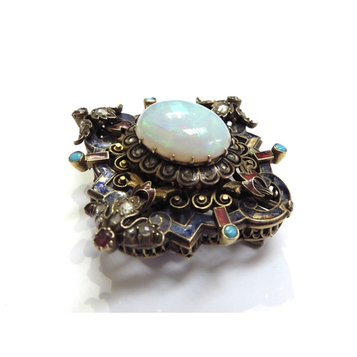 6340 - An ornate enamelled brooch studded with old cut diamonds, cabochon turquoise and rubies, the centre ... 