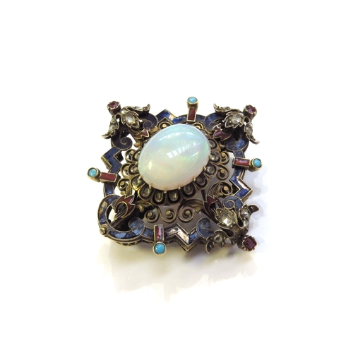 6340 - An ornate enamelled brooch studded with old cut diamonds, cabochon turquoise and rubies, the centre ... 