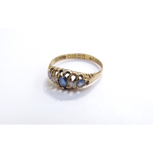 6320 - An 18ct gold five stone sapphire and diamond ring in open scroll mount, Birmingham, 1910. Size P, 2.... 