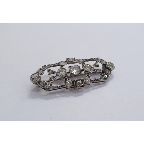 6005 - An Art Deco diamond encrusted brooch the centre diamond 0.50ct approx, unmarked platinum, 4.6cm long... 