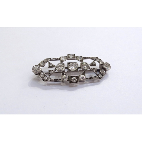 6005 - An Art Deco diamond encrusted brooch the centre diamond 0.50ct approx, unmarked platinum, 4.6cm long... 