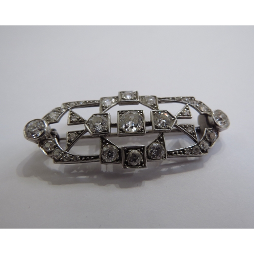 6005 - An Art Deco diamond encrusted brooch the centre diamond 0.50ct approx, unmarked platinum, 4.6cm long... 