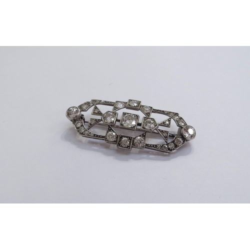 6005 - An Art Deco diamond encrusted brooch the centre diamond 0.50ct approx, unmarked platinum, 4.6cm long... 