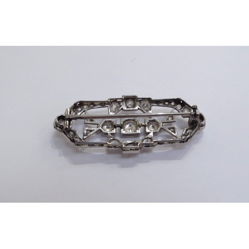 6005 - An Art Deco diamond encrusted brooch the centre diamond 0.50ct approx, unmarked platinum, 4.6cm long... 