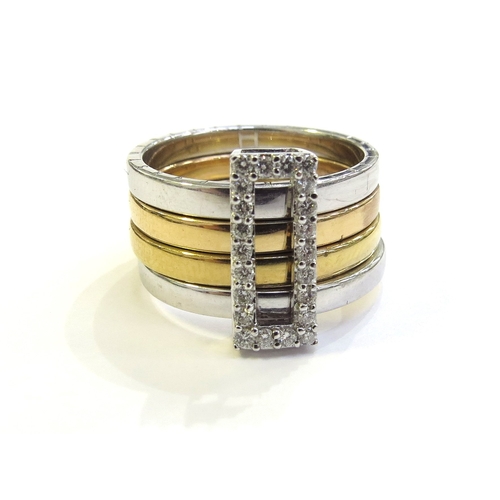 6263 - A tri colour gold ring with four bands, held together with a sliding diamond set buckle, the outer b... 