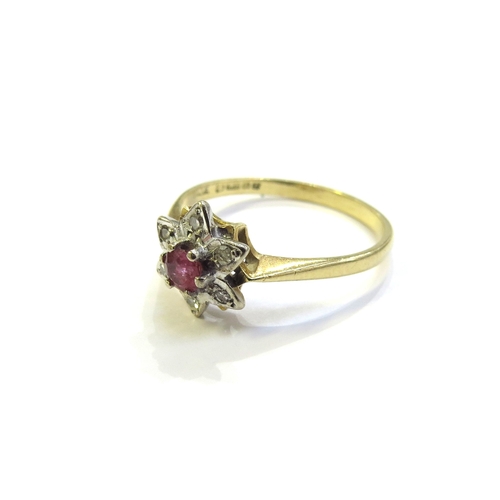 6051 - An 18ct gold ruby and diamond cluster/star ring. Size Q/R, 2.8g