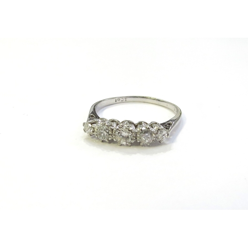 6048 - A white gold five stone graduated diamond ring, stamped 18ct. Size O, 2.2g