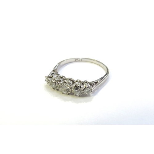 6048 - A white gold five stone graduated diamond ring, stamped 18ct. Size O, 2.2g