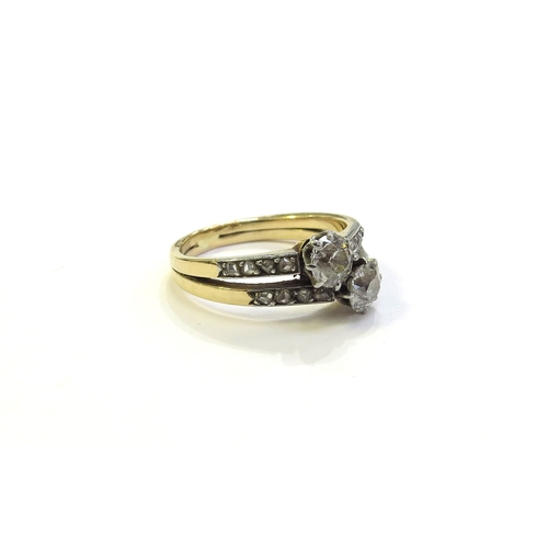 6181 - A double band diamond cross over ring with diamond set shoulders, unmarked gold. Size K, 3.4g