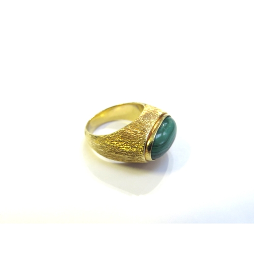 6300 - A signet ring set with malachite in textured shank, marked 18ct CONTI. Size N, 11.1g