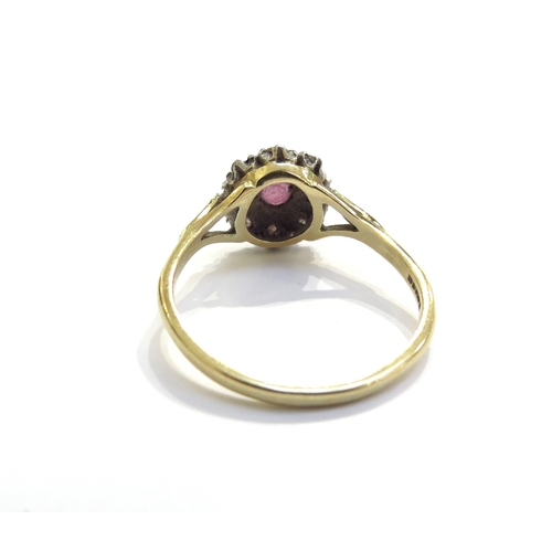 6279 - An 18ct gold ruby and diamond cluster ring. Size U, 4.2g