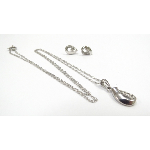 6325 - A 9ct white gold chain 50cm long, hung with a diamond pendant with a pair of matching stud earrings,... 