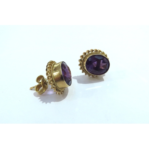 6020 - A pair of 9ct amethyst stud earrings the oval amethyst 10mm x 8mm in a rope twist frame, 2.8g