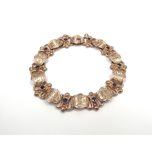 6177 - A 9ct rose gold bracelet with engraved panels separated with links set with single sapphires, 20cm l... 