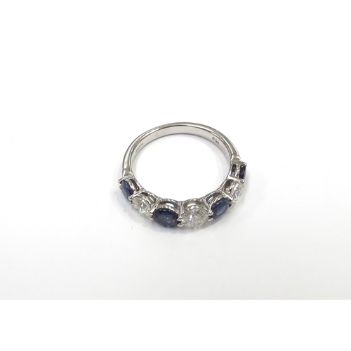 6001 - An 18ct white gold seven stone ring set with alternating sapphires and round cut diamonds. Size P, 4... 