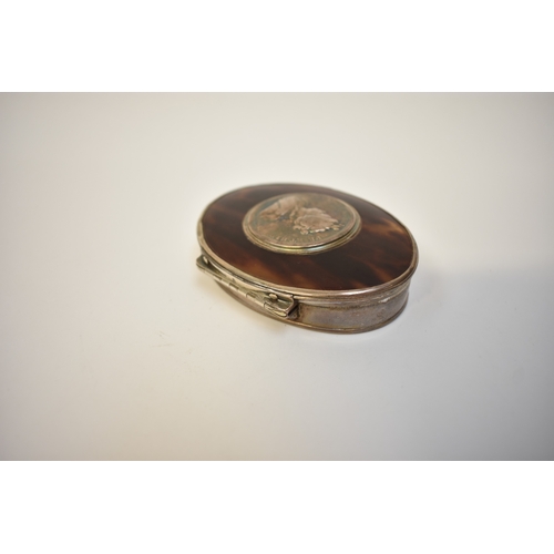 8010 - An early 18th Century oval silver and tortoiseshell snuff box, the lid set with a Queen Anne treaty ... 