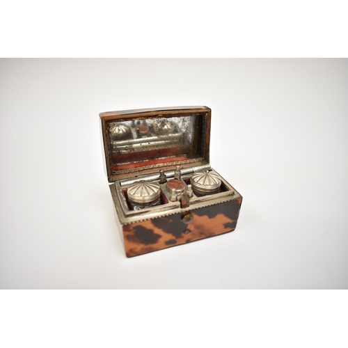 8021 - A late 18th Century tortoiseshell lady's writing case with hinged cover, revealing an inset mirror, ... 