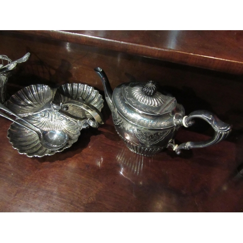 4018 - A plated tea pot with ebonised knop, wine basket, cake servers and a plated scallop shell form tray