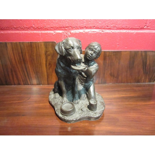 4089 - A Heredities cold-cast bronze figure of a boy feeding a dog, 12cm tall.