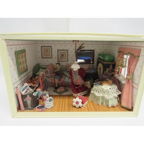 5055 - Two wooden cased dolls house room dioramas in wooden cases with sliding perspex fronts, one depictin... 