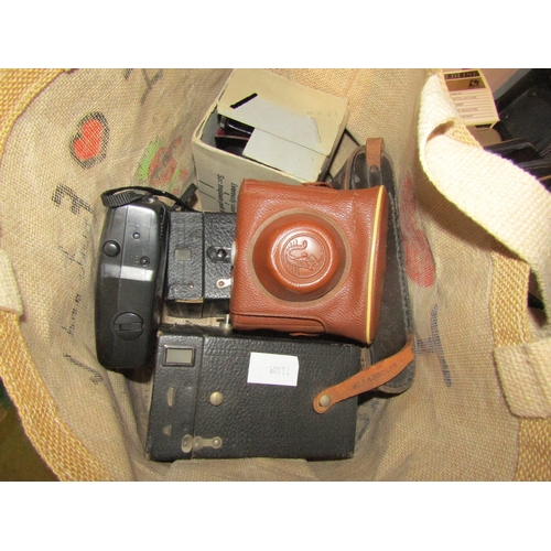 4228 - A box and a bag containing a collection of 35mm & box cameras w/ accessories