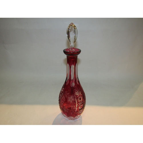 4315 - An etched and cut cranberry glass wine decanter of slender form with stopper