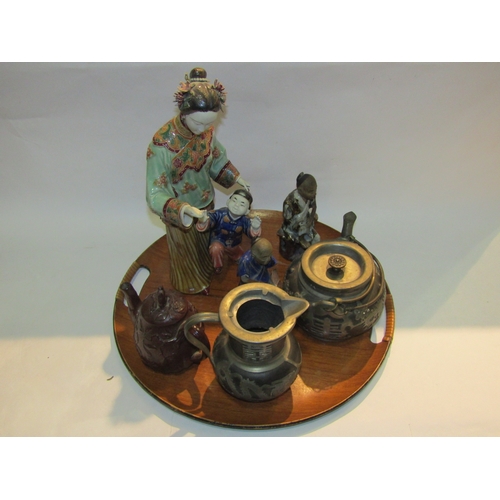 4324 - An Oriental tray containing three Oriental figures, two teapots and water jug