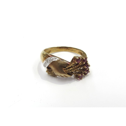 6154 - A 14ct gold ring, hands clasping a posy of flowers with ruby set to ends, diamond bracelet to wrist.... 