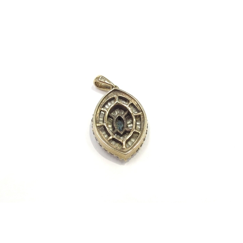 6212 - A 9ct gold pendant, centrally set with a small oval sapphire framed by baguette and round cut diamon... 