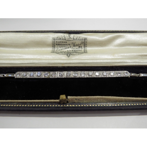 6006 - An Art Deco 18ct white gold diamond line bracelet, 16 brilliant cut diamonds in square milgrain sett... 