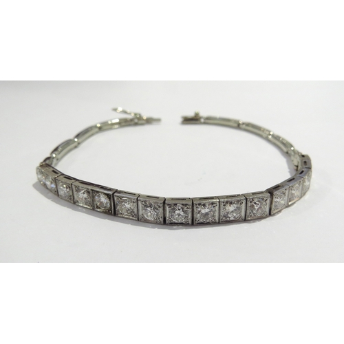 6006 - An Art Deco 18ct white gold diamond line bracelet, 16 brilliant cut diamonds in square milgrain sett... 