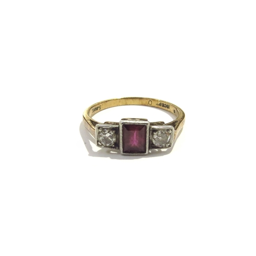 6176 - An 18ct gold ring centrally set with an emerald cut ruby flanked by diamonds in square mounts. Size ... 