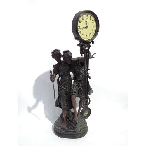 4122 - A large reproduction bronze effect figural mystery clock with quartz movement, 78cm tall