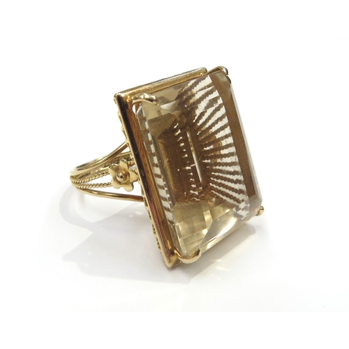 6281 - A gold ring set with a large rectangular citrine, 2.5cm x 1.8cm, unmarked gold. Size M, 16.1g