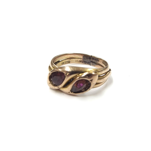 6274 - A 9ct gold ring as a two coiled snakes with garnet heads, has been re-sized. Size O, 4.9g