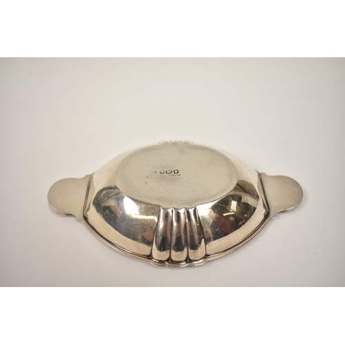 8063 - A Louis Simpson Ltd silver scallop handled bowl/dish, London 1946 Rd 847541, 2.5cm x 17.5cm long, 13... 